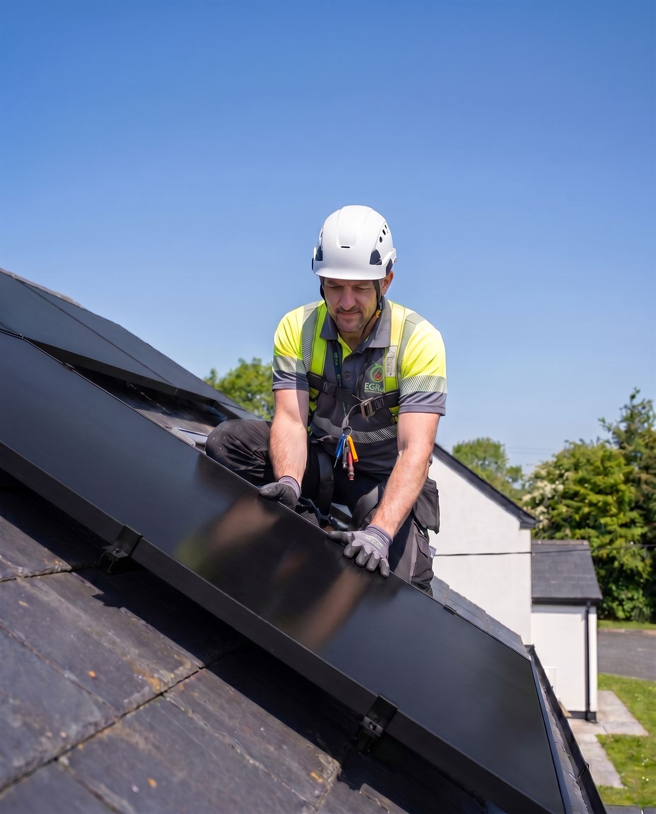 EGR installer fitting a solar PV panel on a roof